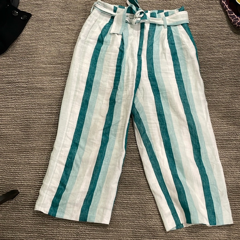 Shades of blue and white vertical stripes. Linen pants cropped at ankle. Linen.